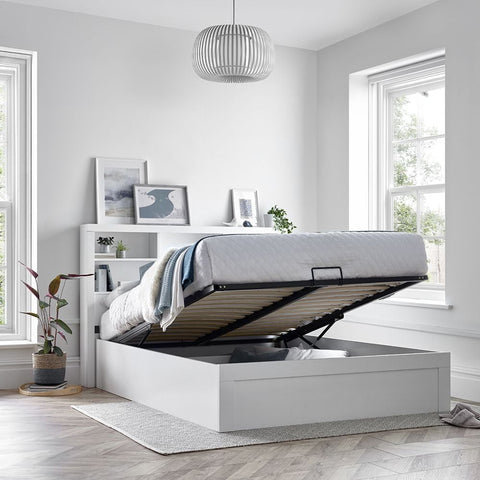 Arizona wooden ottoman storage bed with gas lift platform raised showing deep under-bed storage in bedroom setting