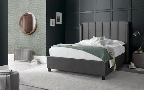 Aurora grey velvet ottoman bed with art deco winged headboard in bedroom setting