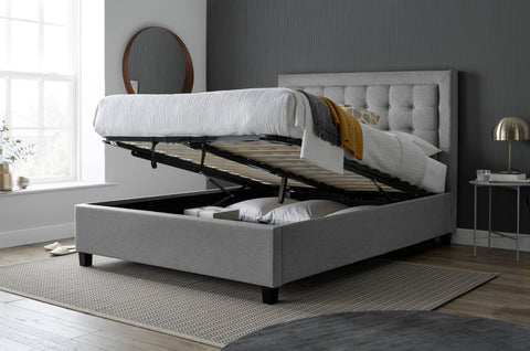 Brandon grey fabric ottoman bed raised open showing hydraulic gas lift mechanism and boarded under bed storage space