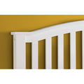 Close-up of the curved slatted headboard on the Grayson white wooden storage bed frame