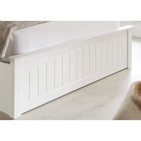 Close-up view of the white paneled solid wood footboard on the Grayson wooden storage bed frame