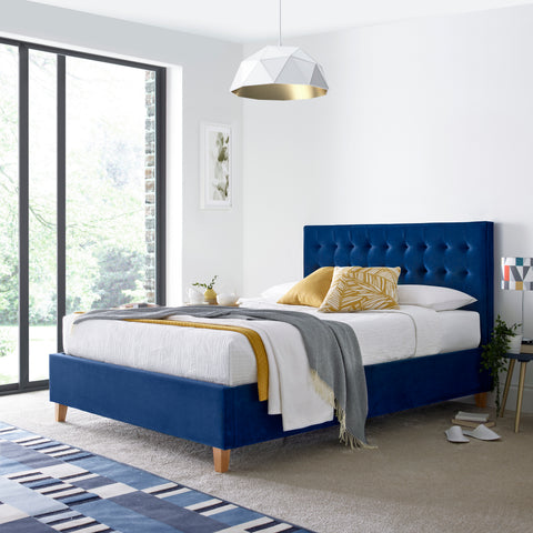 Kingham blue velvet ottoman bed styled in a bedroom setting
