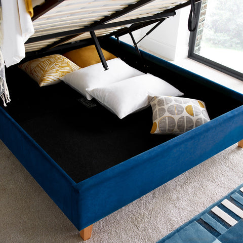 Kingham blue velvet gas-lift ottoman bed lifted open displaying deep under-bed storage space