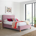 Kingham pink velvet ottoman bed frame styled in a modern bedroom setting