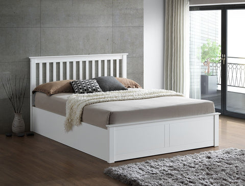 Malmo white wooden ottoman bed with slatted headboard styled in a bedroom setting