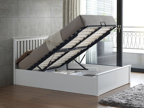 White Malmo wooden ottoman bed raised with gas lift showing under-bed storage compartments