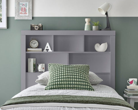 Close up of integrated bookcase headboard shelving on grey Oscar wooden gas lift single bed
