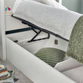 Close up of deep under-bed storage cavity and base on white Oscar wooden gas lift single bed