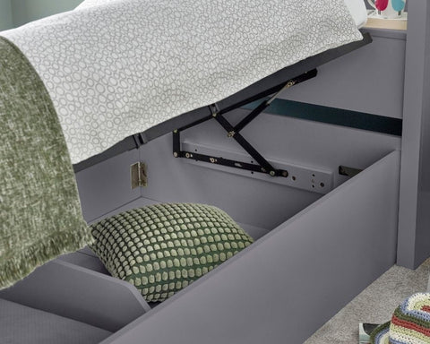 Close up of deep under-bed storage compartment on grey Oscar wooden gas lift single bed
