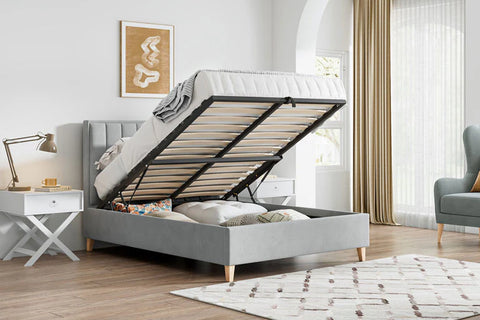 Rhodes grey velvet ottoman bed shown open with spacious underbed storage in a bedroom setting
