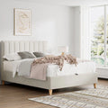 Rhodes warmstone velvet ottoman bed styled with grey bedding in a bright bedroom with large windows