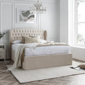 Warwick velvet ottoman bed in natural cream styled in a modern bedroom setting with winged headboard