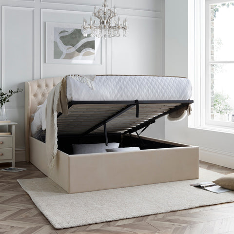 Warwick velvet ottoman bed in natural with open gas lift storage showing fully boarded base in bedroom
