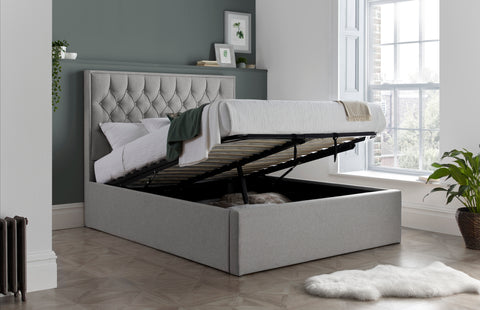 Wilson grey fabric ottoman bed with gas-lift base open showing extra deep 30cm boarded storage space